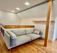Living space in a family house with a wooden decor floor and a comfortable couch.