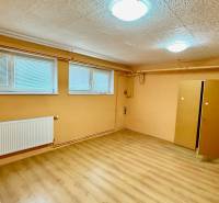 A room in a family house with a wooden decor floor, a radiator, and a wardrobe.