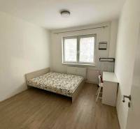 Bedroom in a 4-room apartment with a bed, window, and floor with wooden decor.