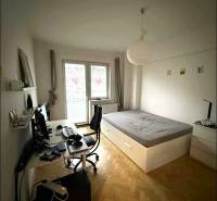 Bedroom with a desk and a bed, wooden decor flooring, 4-room apartment.