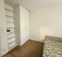 A room in a 4-room apartment with a wooden decor floor and a built-in wardrobe.