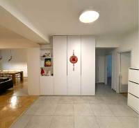 Interior of a 4-room apartment with tiles, seating area, and flooring with a wood decor.