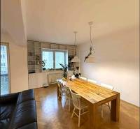 Dining table and chairs, large window, wooden decor flooring, 4-room apartment.
