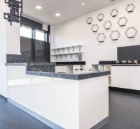 Commercial space with an elegant kitchen set, decorative elements, and large windows.