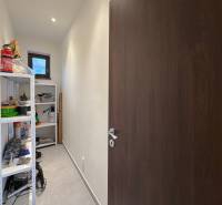 Storage space with shelves and cleaning products in a family house.