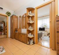 Hallway in a 3-room apartment with ceramic flooring, wooden decor, and decorative items.