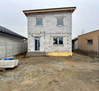 Unfinished family house on Hviezdna Street in Čaňa with surrounding buildings.