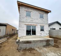 An unfinished family house in Čaňa on Hviezdna Street, with a concrete terrace.