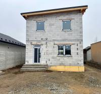 A family house on Hviezdna Street in Čaňa with an unfinished facade and fencing.