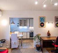 Interior of a 2-room apartment with a kitchen, a work nook, and decorative wall elements.