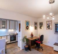 Living room connected to the kitchen in a two-room apartment, floor with wooden decor.