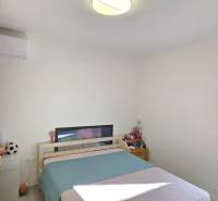 Bedroom with a double bed and a cabinet in a 3-room apartment.