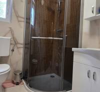 Bathroom in a 3-room apartment with a toilet, shower, and sink.