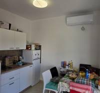 Kitchen in a 3-room apartment with a kitchenette, table, and appliances.
