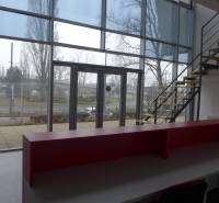 Reception with a staircase and large windows in commercial premises.