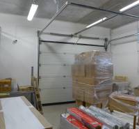 Storage spaces with boxes, steel shelves, and a roll-up door.