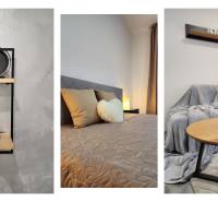 Clock decoration, bed with pillows, and sofa with coffee table in a 2-room apartment.
