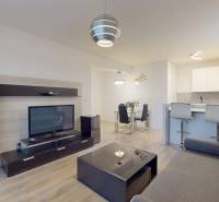 Living room in a 3-room apartment with a wooden decor floor and a TV wall.