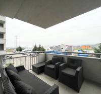 A balcony with garden furniture in a 3-room apartment, view of Sedličná in Trenčianske Stankovce.