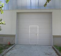 Gate with doors, white facade, trees, Warehouses and halls in Bratislava - Nové Mesto.