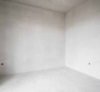 An empty room with white walls in a family house, ready for finishing.