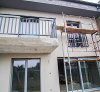 A family house in Nové Zámky is in the reconstruction phase with scaffolding on the facade.