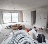 A construction project in a family house with a view of the terrace. Minimalist interior and preparation of electrical installation.