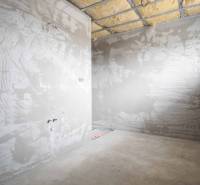 The interior construction of a family house with unfinished plastering and insulation.