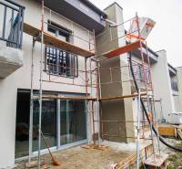 A family house in Nové Zámky during renovation, with scaffolding and balconies with railings.