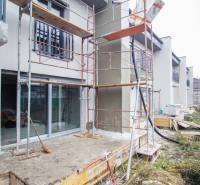 A family house in Nové Zámky during renovation, scaffolding by the entrance door.