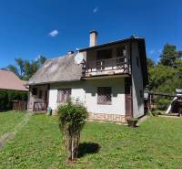 A cottage in Dolné Strháre with a large garden and a satellite dish on the roof.