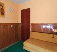 Part of the interior with wooden paneling, a sofa, and wall decoration in the cabin.