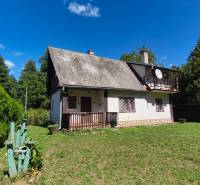 A cottage in Dolné Strháre surrounded by greenery and a clear sky.