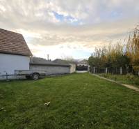 A family house on Krátka Street in Blatné with a grassy yard and a trailer.