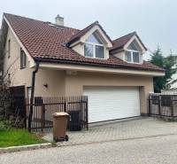 A family house on Mozartova Street in Bratislava - Staré Mesto with a sloped roof and a garage.