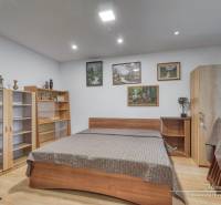 A bedroom in a 3-room apartment with wooden furniture and a floor with a wooden decor.