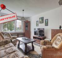 Living room with furniture in a 3-room apartment and a carpet. Reserved.