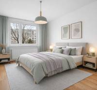 Bedroom in a 4-room apartment with a bed, decorative pillows, and a floor with a wooden decor.