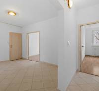 Entrance hallway in a 4-room apartment with light flooring and white walls.
