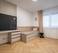 Children's room in a 3-room apartment with a board, bed, and floor with a wooden decor.