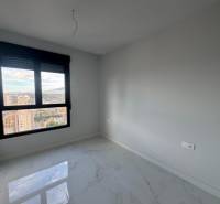 An empty room with a bright floor and a view in a 3-room apartment with marble.