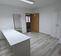 Offices with white furniture and wood-patterned flooring.