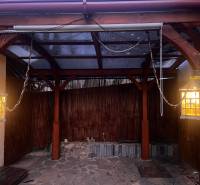 A wooden gazebo in a family house in Tvrdomestice with lights and a stone floor.