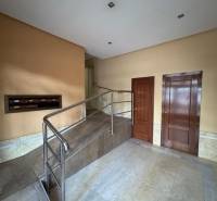 Interior with entrance hall and ramp in a 4-room apartment with marble cladding.