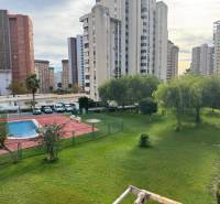 View from a 4-bedroom apartment in Benidorm, showing a pool and greenery between the apartment buildings.