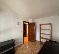 A room with light walls in a 4-room apartment with a wood-patterned floor.