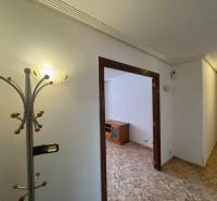 Interior of a 4-room apartment with a hallway and a coat rack, floor with wood decor.