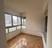 A room in a 4-room apartment with a wood-patterned floor and large windows.