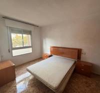 Bedroom with a bed and nightstands in a 4-room apartment. Floor with wood decor.