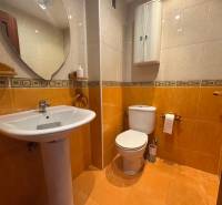 Bathroom in a 4-room apartment with a toilet and a floor with a wooden decor.